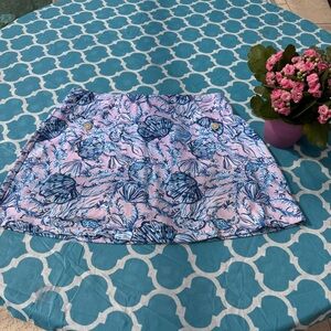 Lilly Pulitzer Madison Skort is a pink and blue featuring a seashell pattern.